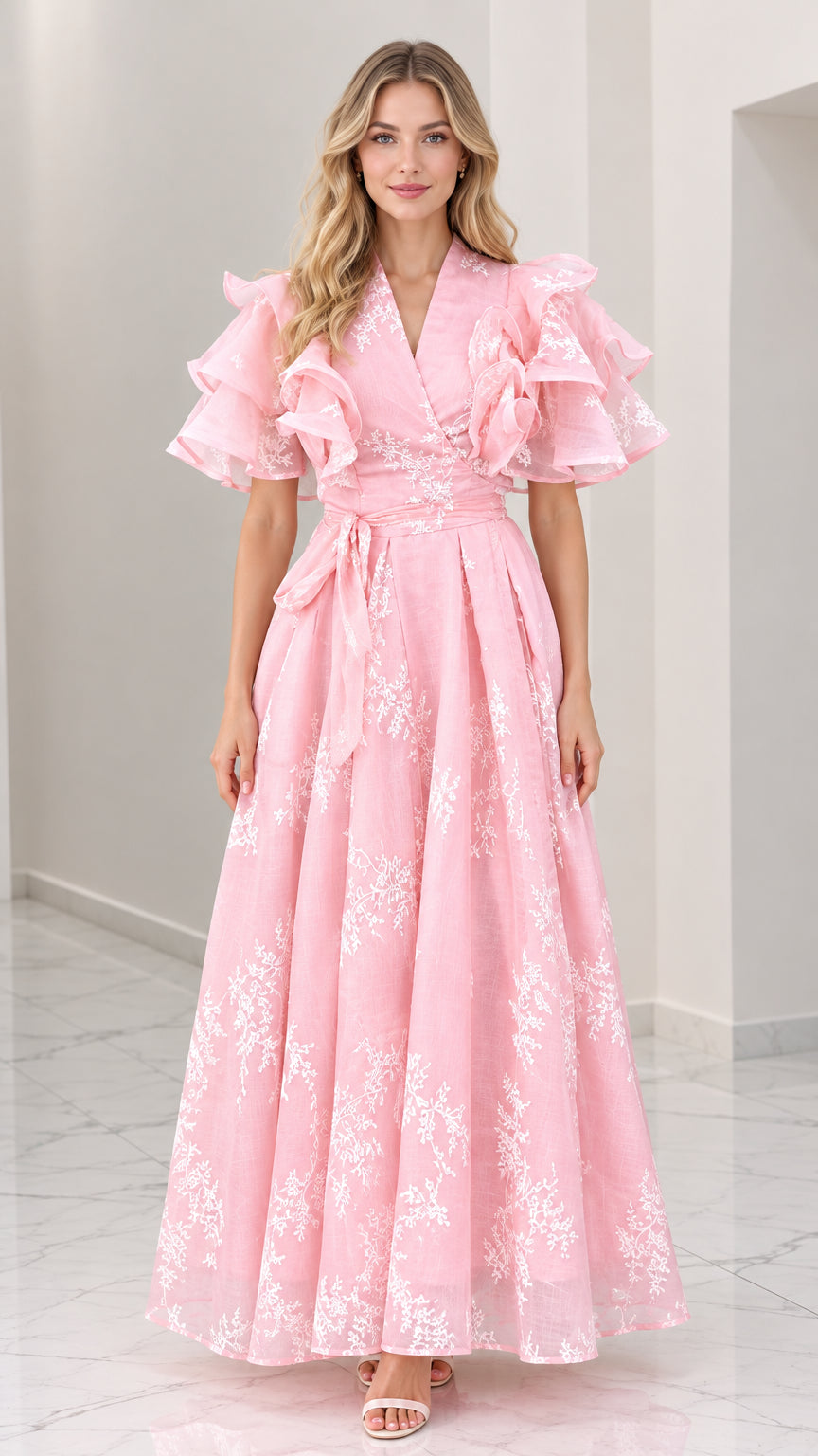 Front full-length view of woman wearing pink floral embroidered maxi dress with tiered ruffle sleeves