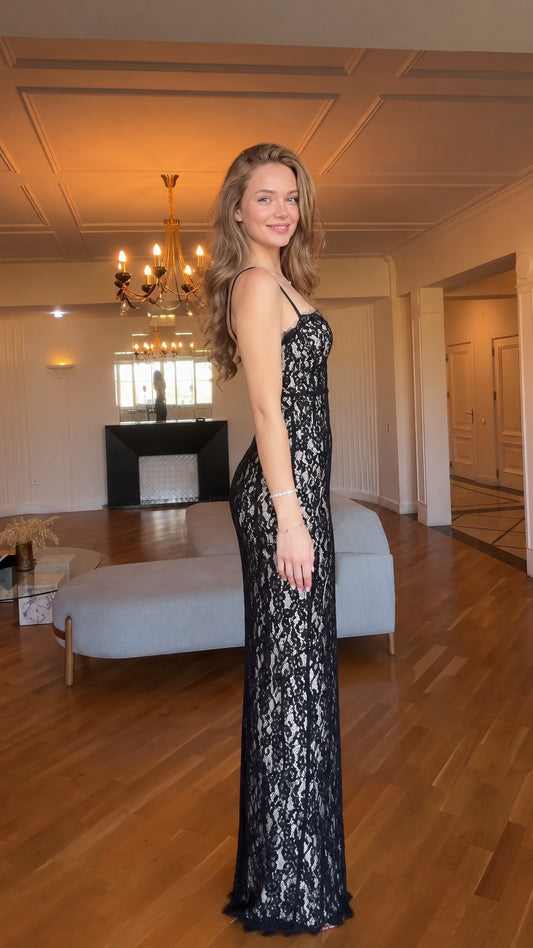 Side profile of woman in black floral lace column maxi gown