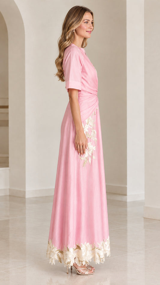 Side profile of woman in pink short-sleeve floral embroidered maxi dress