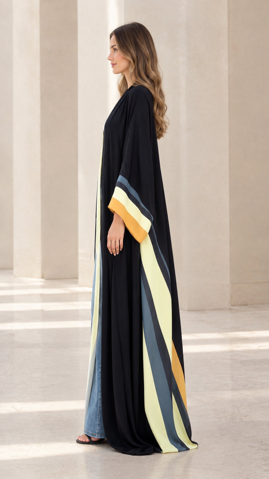 Side profile view of black long kimono duster showcasing contrast sleeve and hem stripes