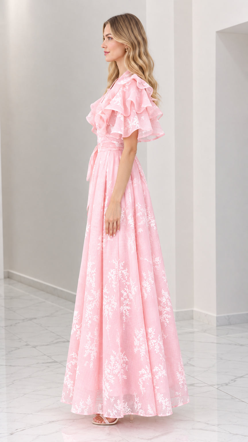 Side view of pink floral embroidered maxi dress showing tiered sleeve detail and floor-length skirt