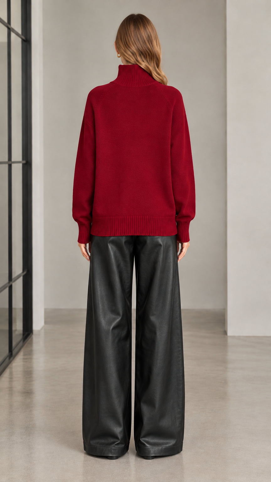 Back view of woman wearing burgundy high neck knit cardigan