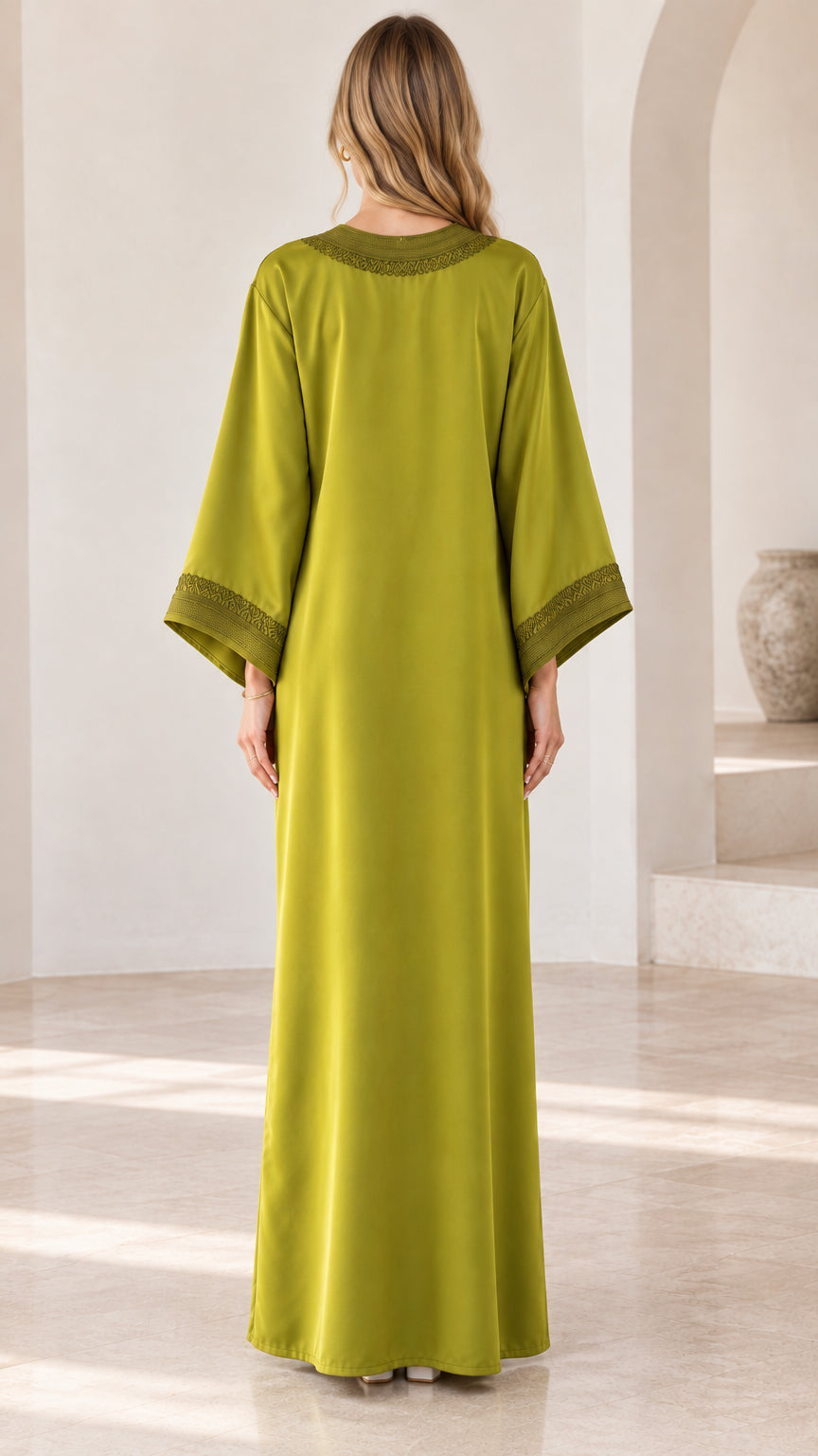 Back full-length view of woman wearing olive green embroidered kaftan maxi dress