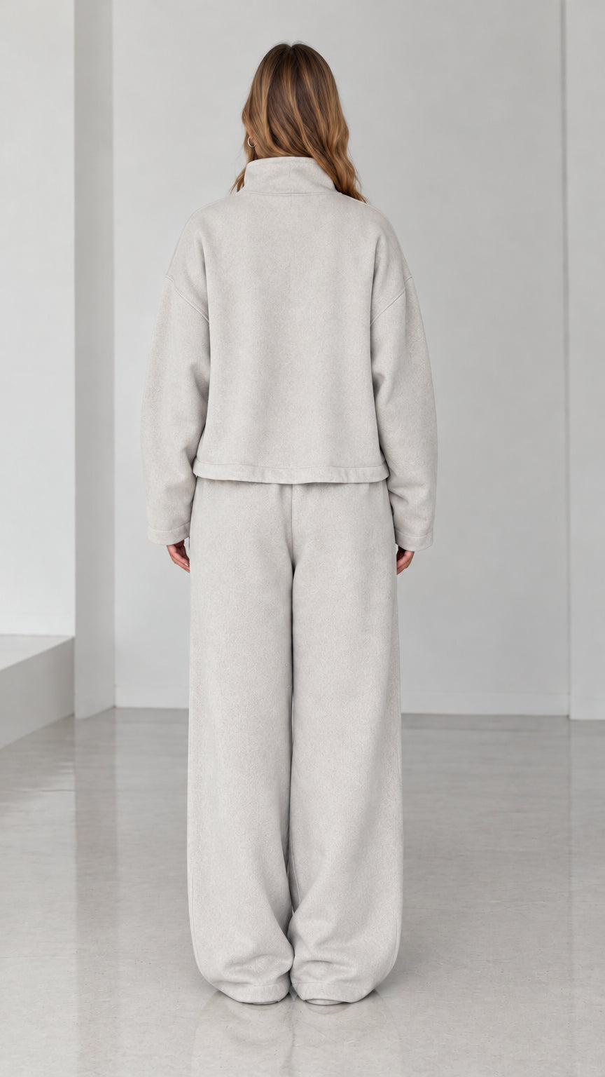 Back view of model wearing Light Gray fleece matching lounge set