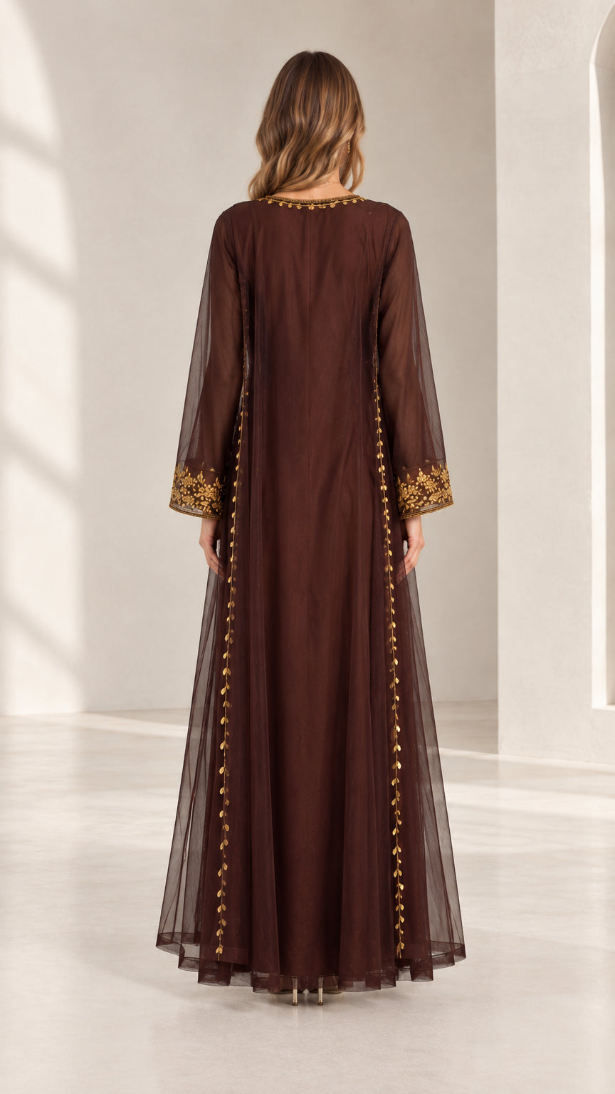 Back full-length view of woman wearing chocolate brown embroidered kaftan maxi dress