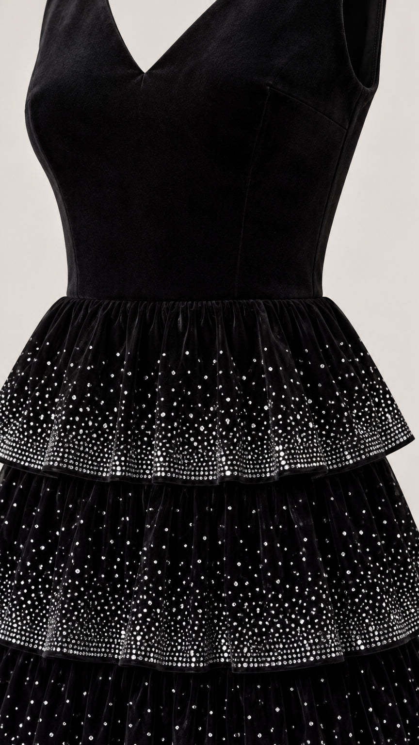 Close-up detail of black velvet bodice and rhinestone-studded tiered skirt