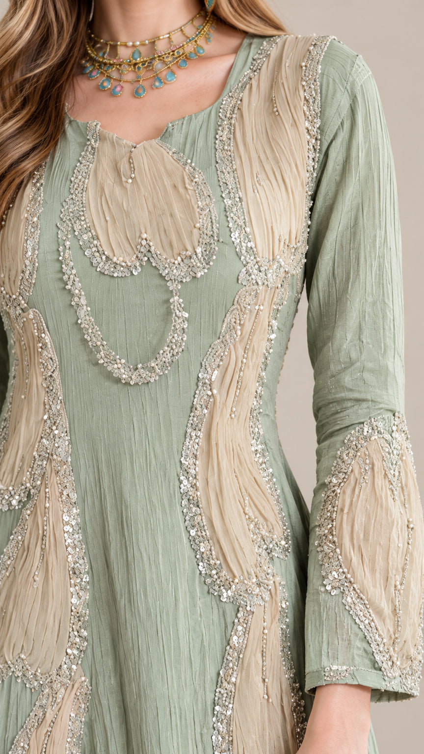 Close-up detail of sage green crinkle fabric with beaded applique trim
