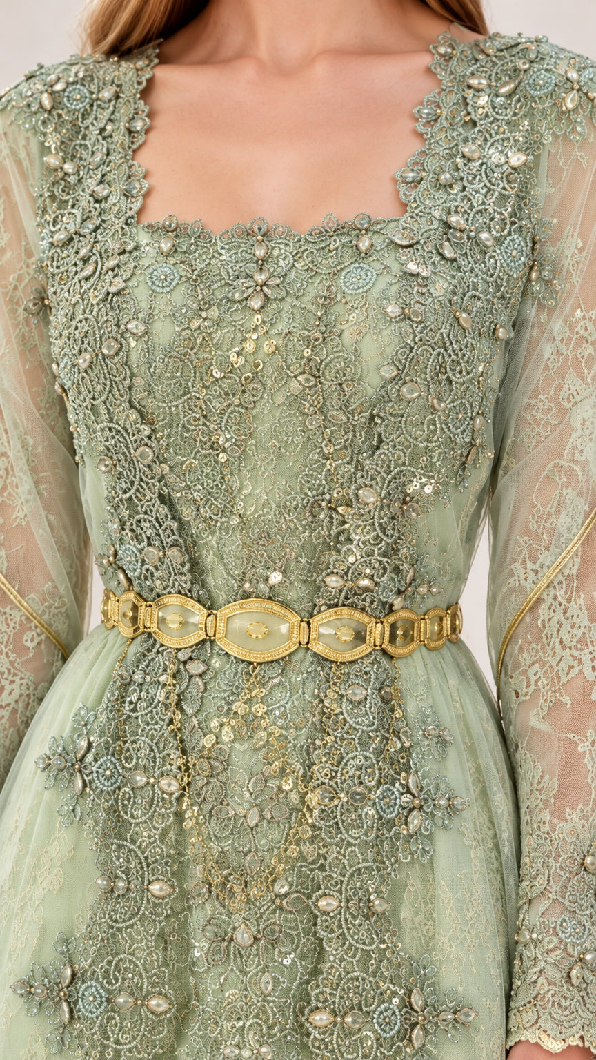Close-up detail of intricate lace embroidery, sequin accents, and gold belt on sage green gown