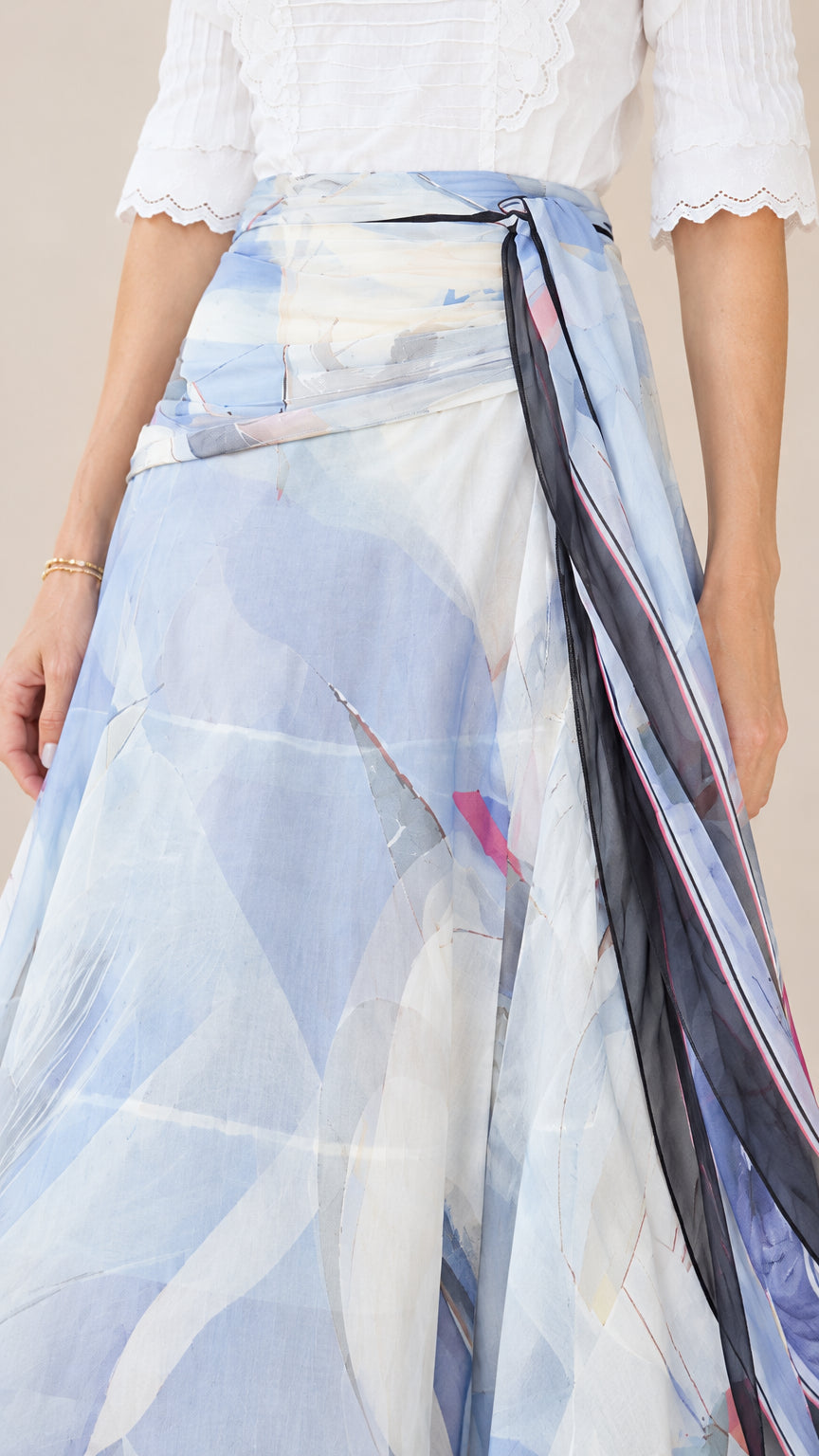 Close-up detail of high waistband with draped tie sash and watercolor fabric texture