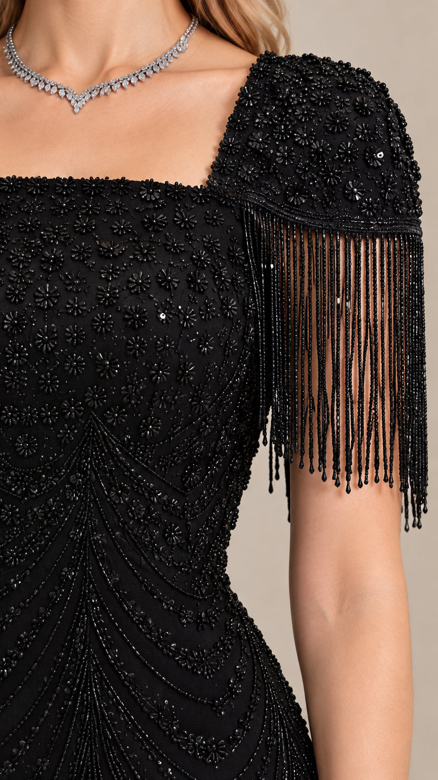 Close-up detail of black beaded bodice and cascading fringe shoulder trim