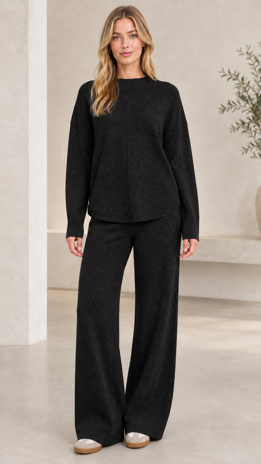 Women's black two-piece crewneck knit sweater and wide-leg pants set