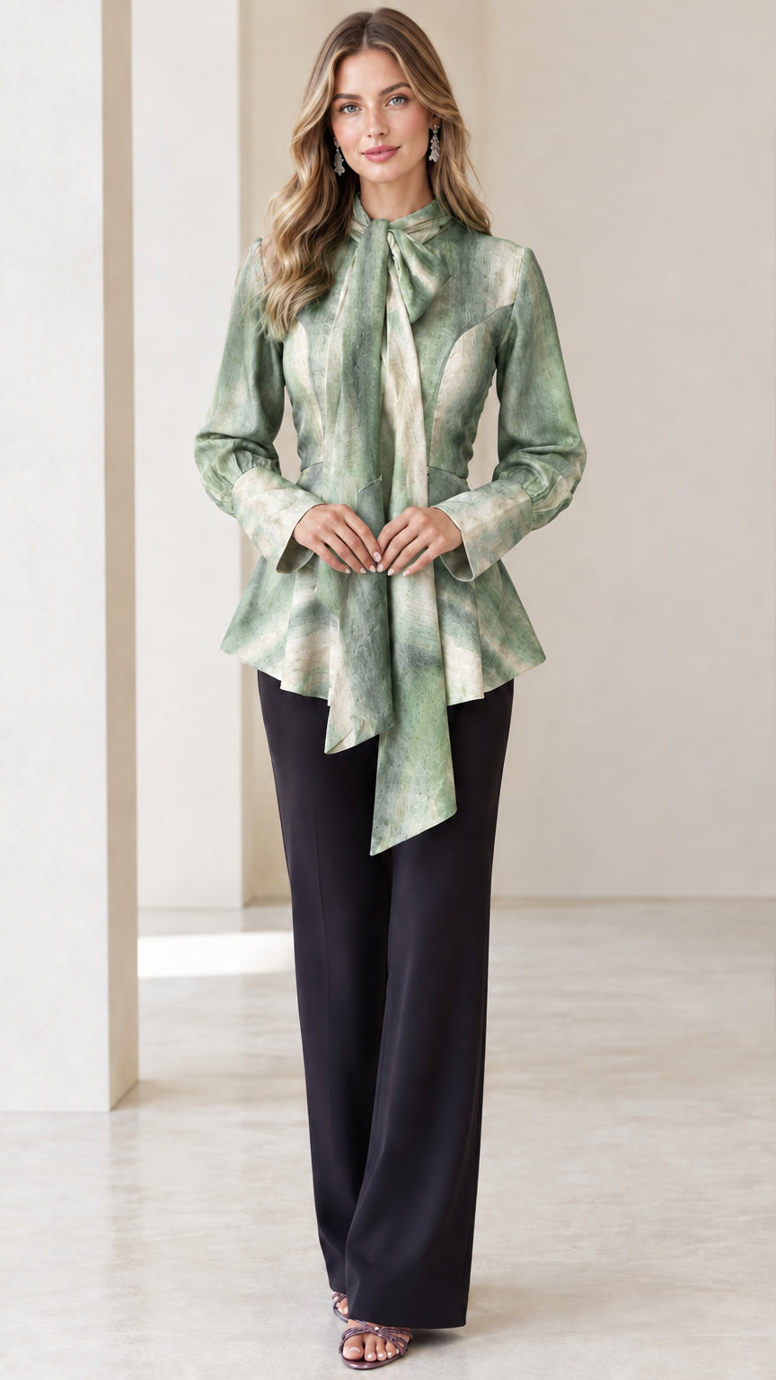Model wearing Sage Green marble tie-neck peplum blouse with black dress pants