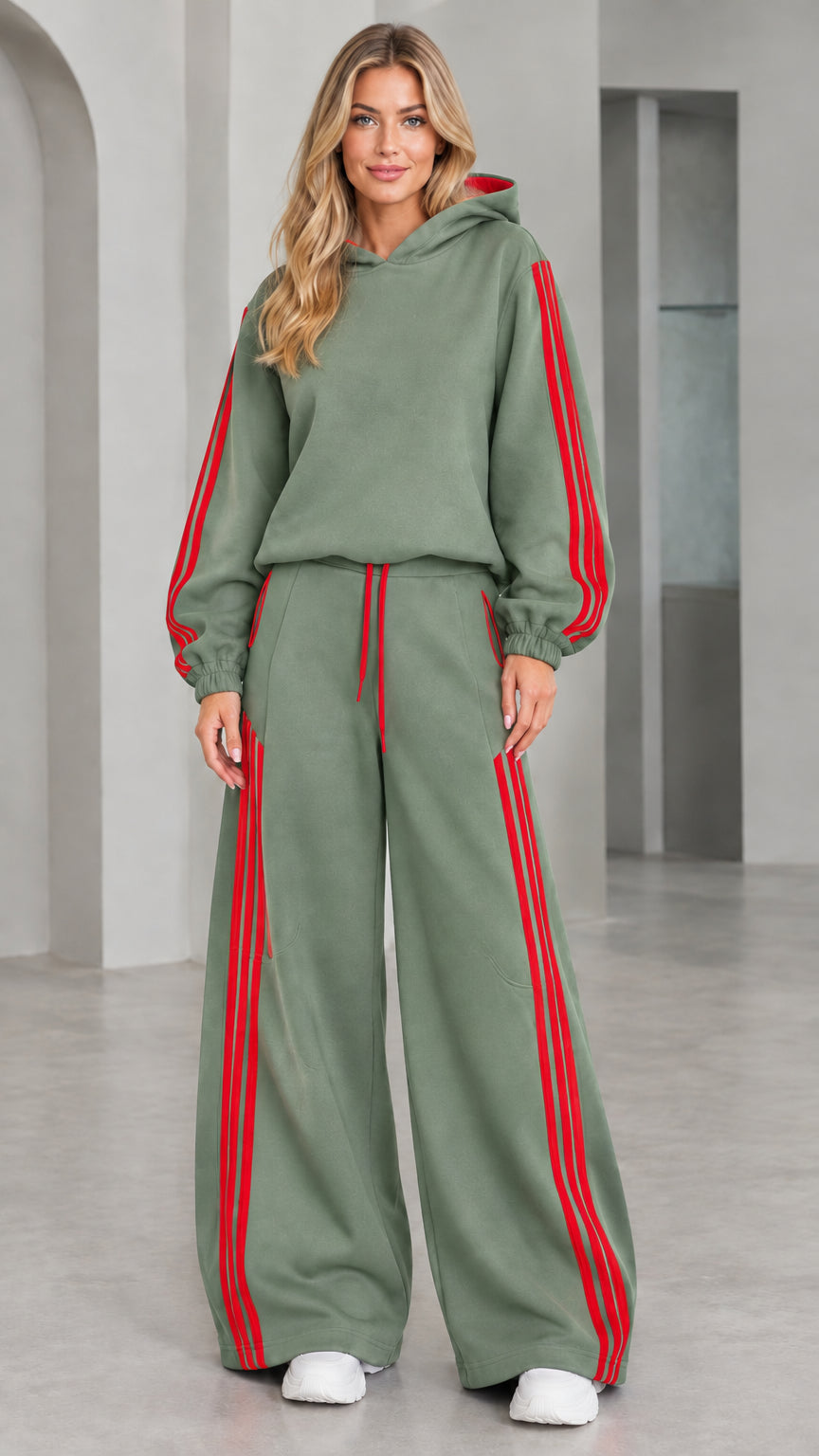 Front view of woman wearing sage green 2-piece wide leg tracksuit set with red stripes