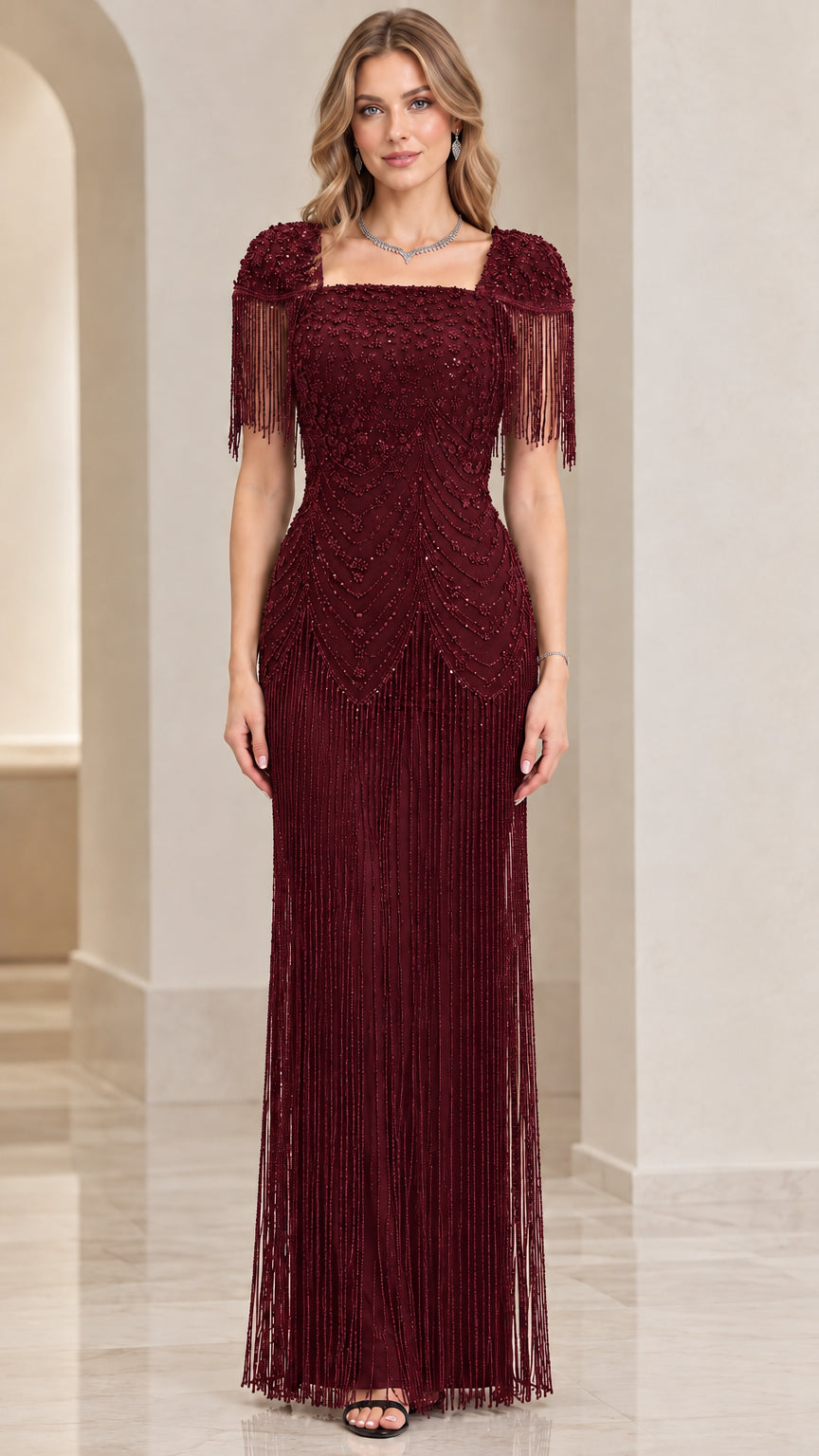 Front view of burgundy beaded maxi formal dress with shoulder fringe