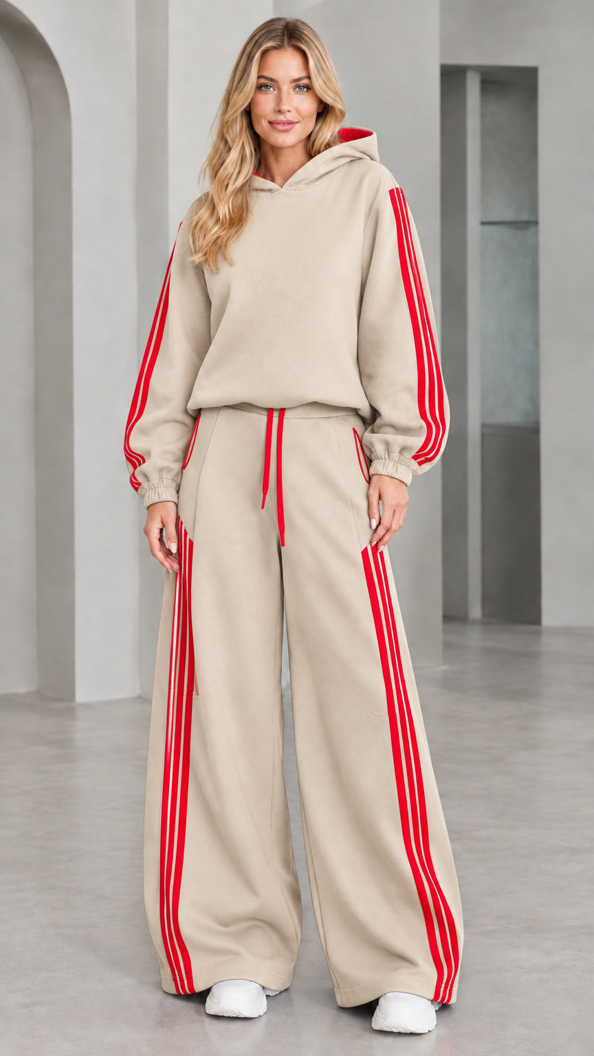 Front view of woman wearing beige 2-piece wide leg tracksuit set with red stripes