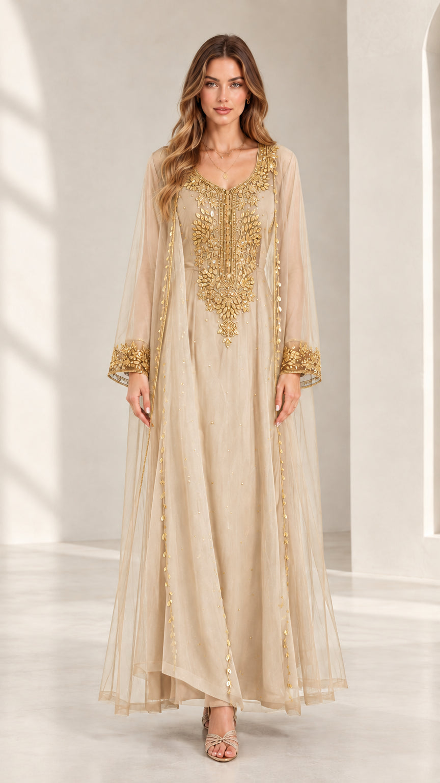 Front view of woman wearing champagne beige embroidered kaftan maxi dress with gold accents