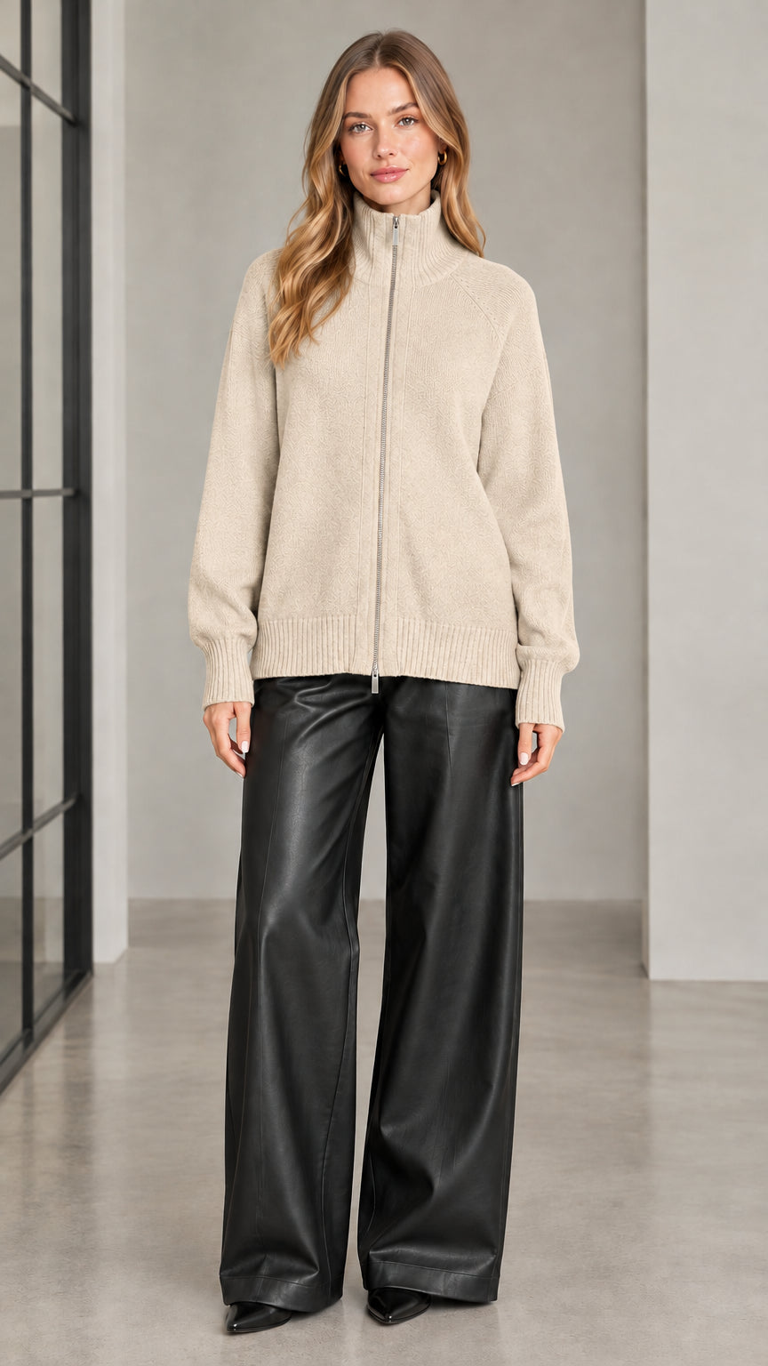 Front view of woman wearing beige full zip knit cardigan sweater