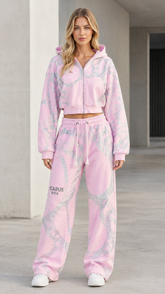 Front view of model wearing pink shimmering graphic cropped hoodie and wide-leg sweatpants set