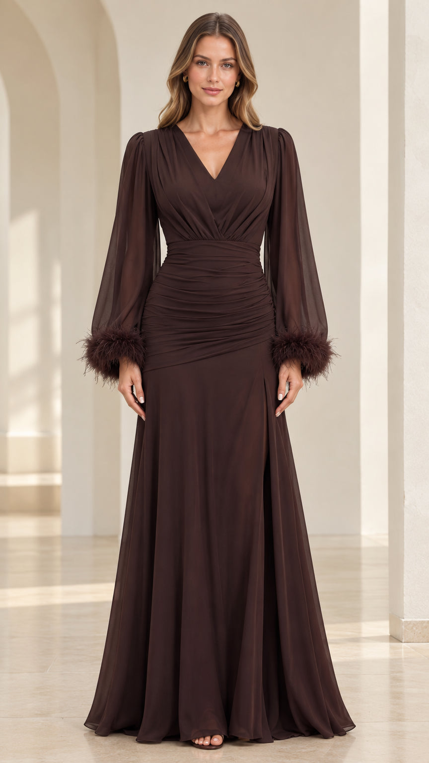 Front view of model wearing floor-length chocolate brown ruched evening gown with feather cuffs