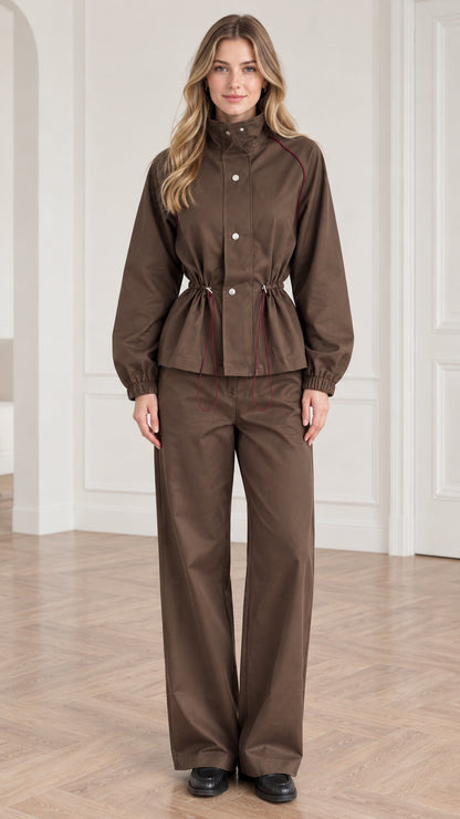 Front view of woman wearing brown utility windbreaker jacket and matching wide leg pants