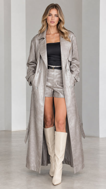 Full-length front view of model wearing metallic silver croc-embossed maxi trench coat
