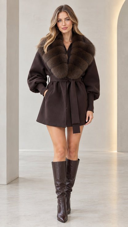 Front view of model wearing chocolate brown faux fur collar belted short coat with tall boots
