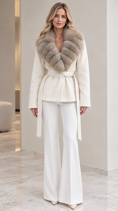 Front view of model wearing ivory belted wrap coat with plush faux fur collar