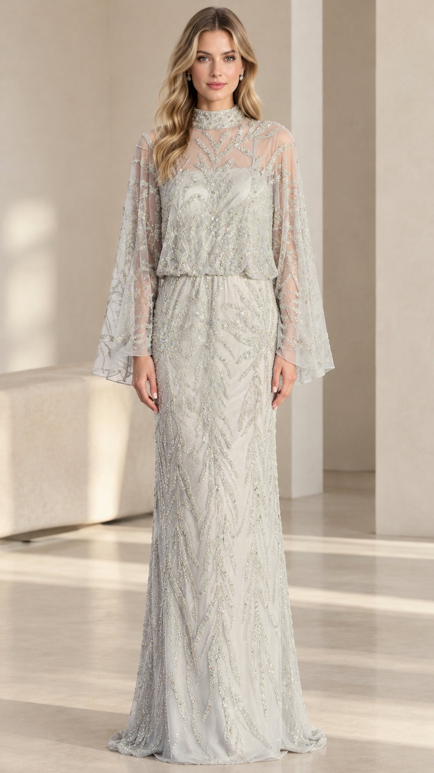 Front full-length view of woman in silver high neck beaded cape sleeve evening gown