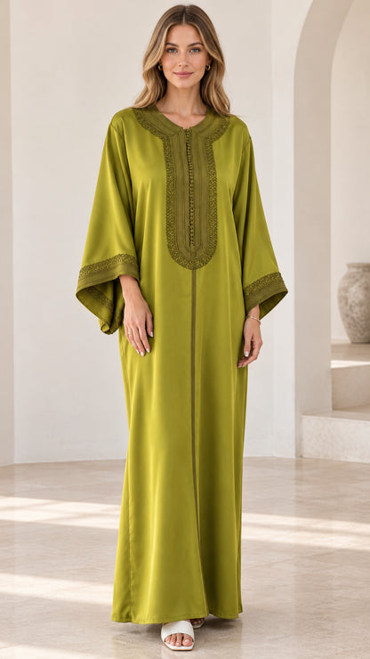 Front full-length view of woman wearing olive green embroidered kaftan maxi dress