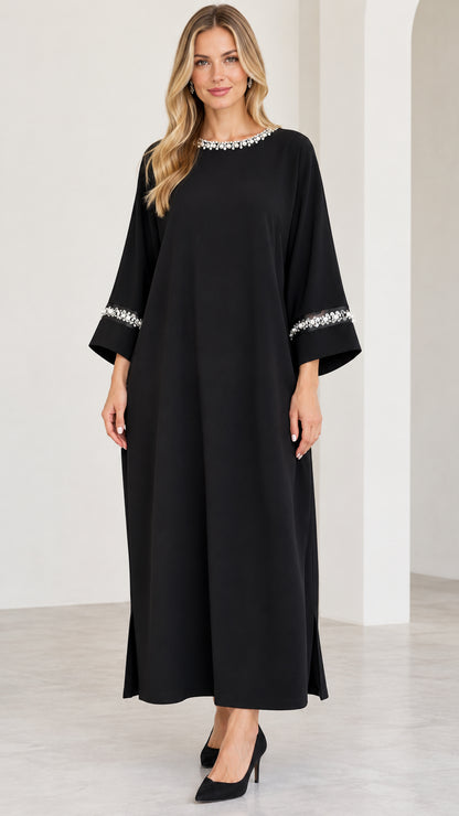 Full front view of model wearing black pearl-embellished kaftan maxi dress