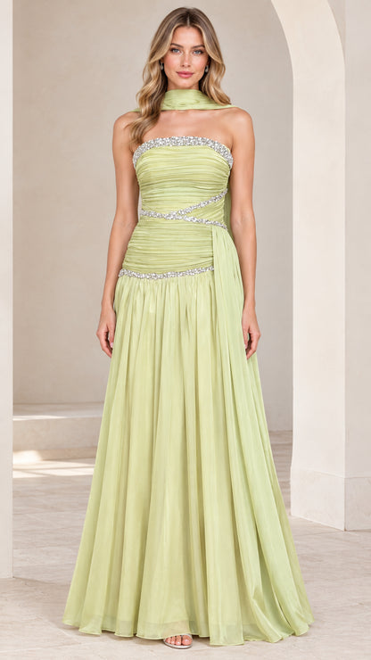 Front full-length view of model wearing light green strapless rhinestone ruched chiffon evening gown with scarf