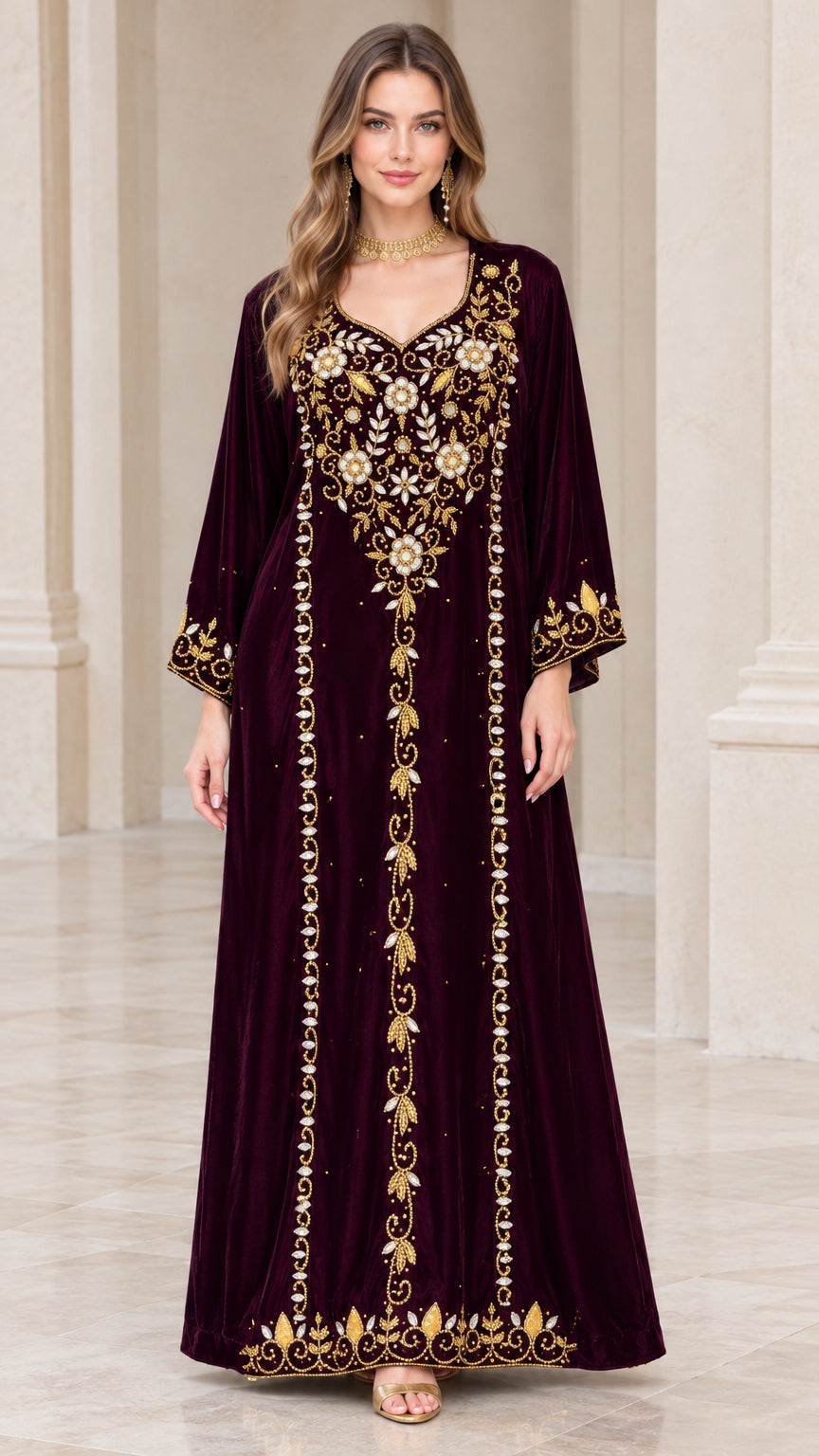 Front view of woman wearing burgundy embroidered velvet kaftan maxi dress with gold beading