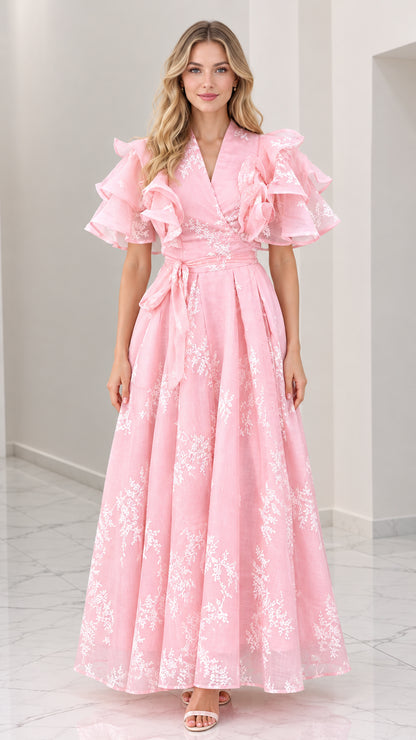 Front full-length view of woman wearing pink floral embroidered maxi dress with tiered ruffle sleeves