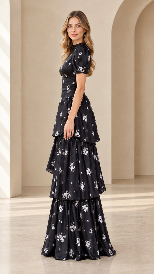 Side angle of model wearing black floral puff sleeve tiered maxi dress