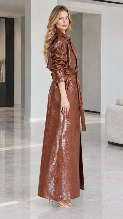 Side profile view of woman modeling longline Cognac Brown croc-embossed belted coat