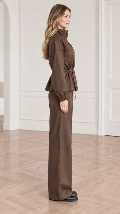 Side profile view of woman wearing brown two-piece drawstring utility matching set