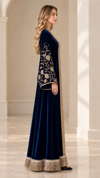 Side profile of navy blue velvet kaftan showing bell sleeves and fringe hem