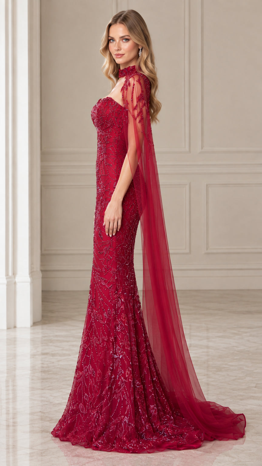 Side angle of burgundy beaded formal gown showing figure-flattering fit and flowing cape