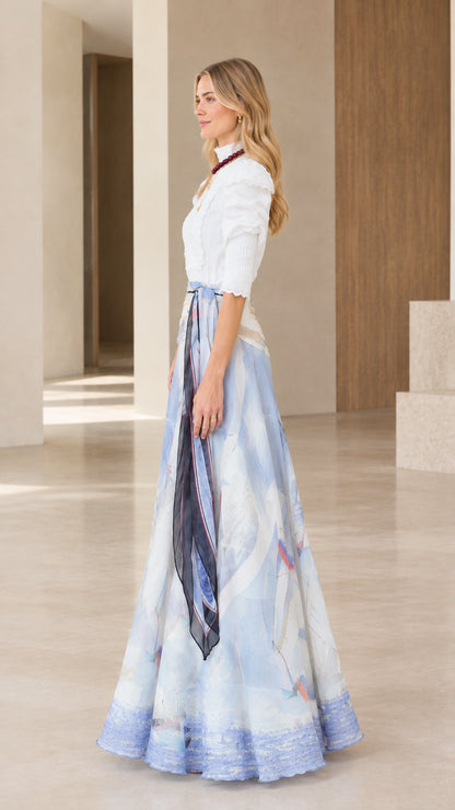 Side profile view of sky blue watercolor print maxi dress with draped side sash