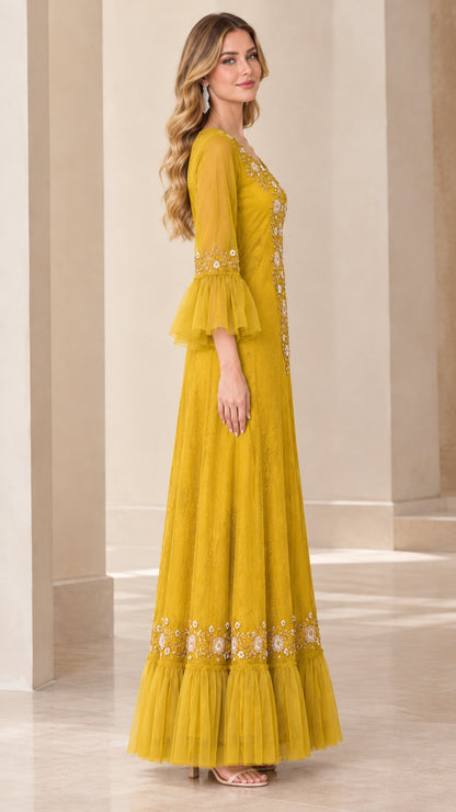 Side angle of mustard yellow formal embroidered evening gown