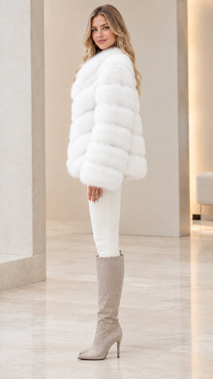 Side profile view of woman wearing plush white fur coat