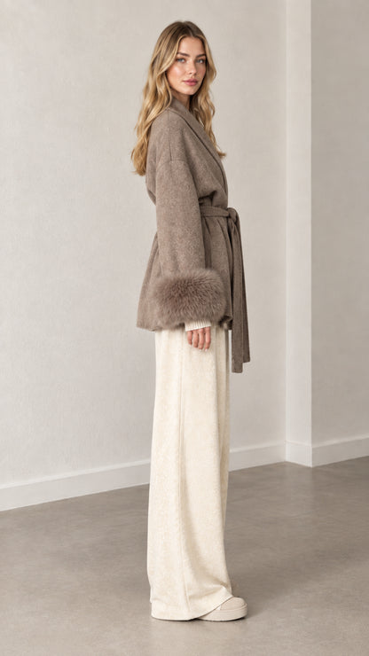 Side profile view of taupe short wrap coat with plush fur cuffs