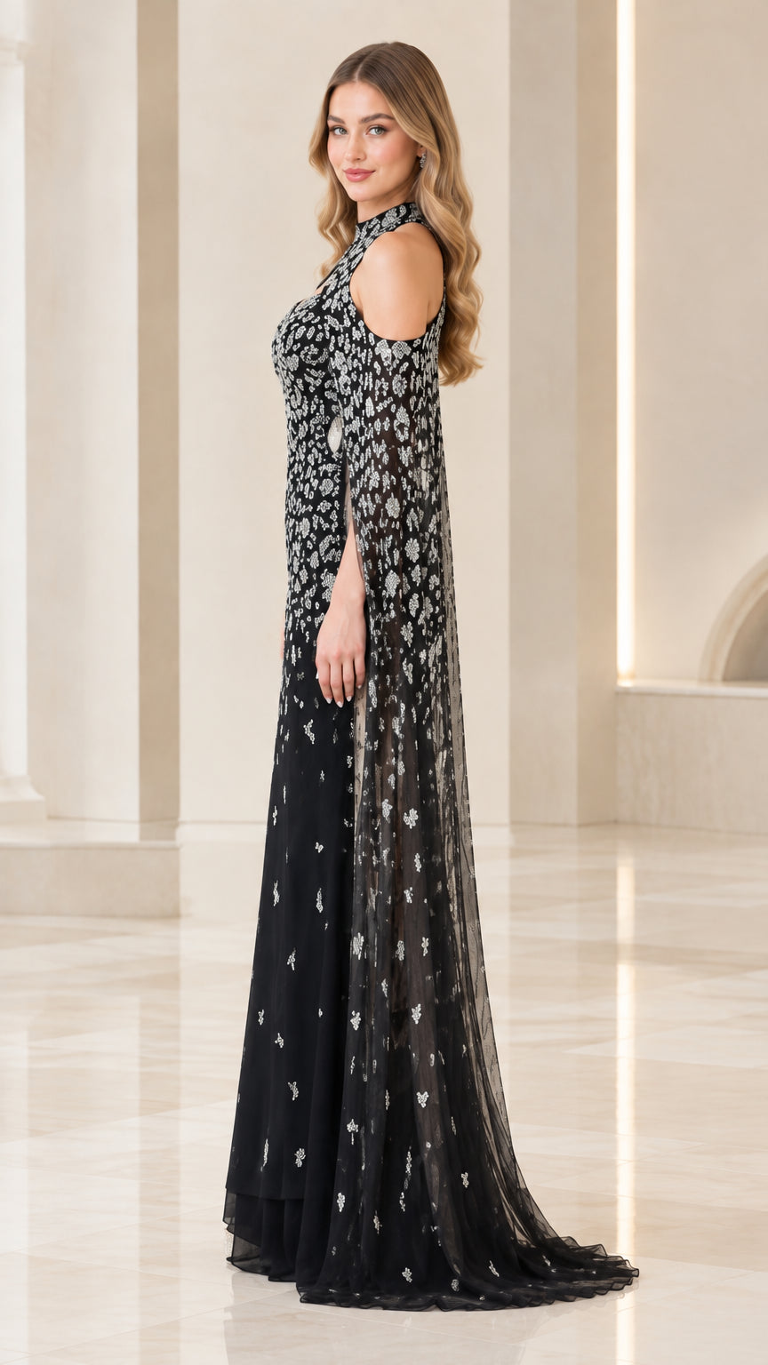 Side view of black sequined cold-shoulder maxi gown with flowing cape