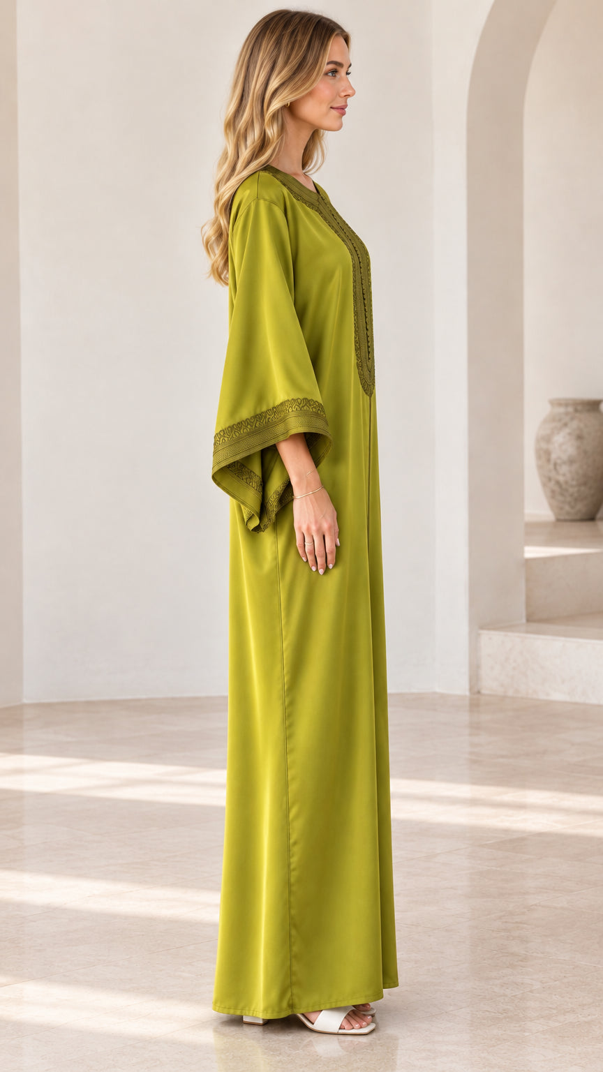 Side profile view of woman wearing olive green embroidered kaftan maxi dress