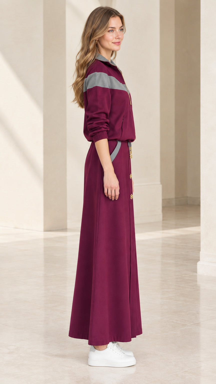 Side profile view of burgundy colorblock two-piece maxi skirt set