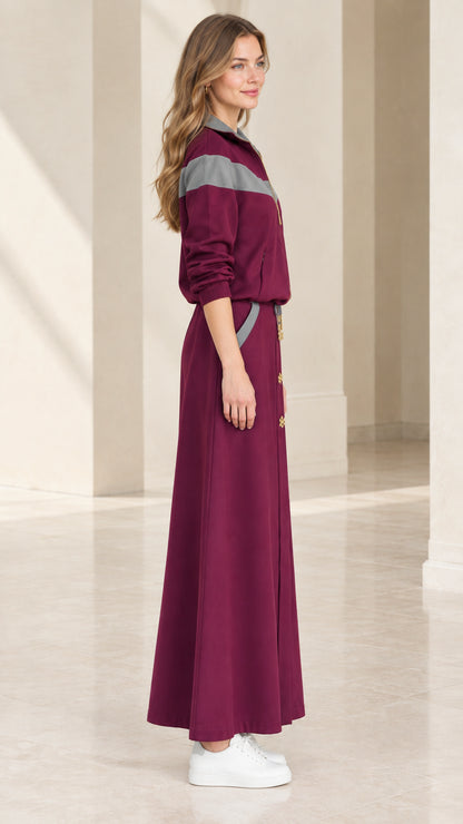 Side profile view of burgundy colorblock two-piece maxi skirt set