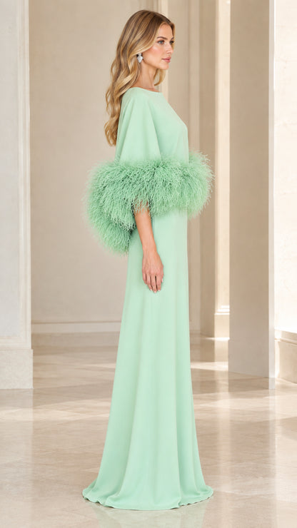 Side profile of model wearing mint green floor-length formal gown with feather sleeves