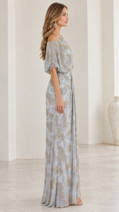Side view of woman wearing slate blue one-shoulder embroidered evening gown