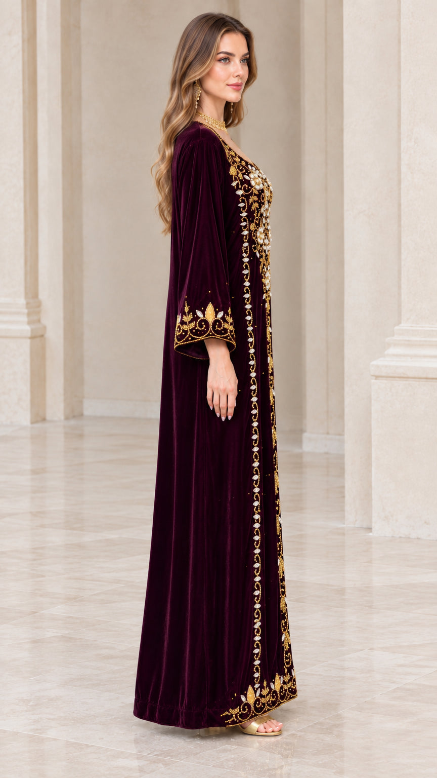 Side profile view of burgundy velvet maxi dress with embellished sleeve cuffs