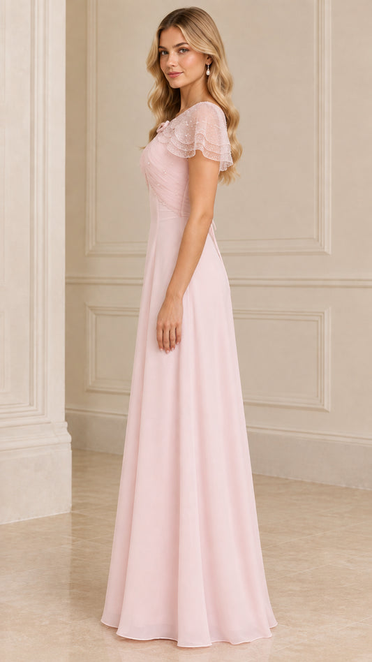 Side profile view of blush pink formal capelet maxi dress